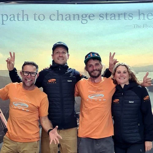 Karlis Jaunpetrovičs with the Flyeo team — Malin Lobb and Fabien Blanco — at a paragliding event.