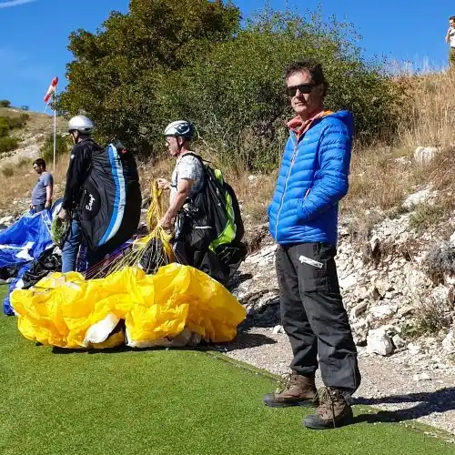 Jacques Daudon, Chief Meteorologist at Flying Karlis SIA, on a paragliding launch field.
